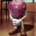 a cartoon apple with arms and legs is sitting on the floor