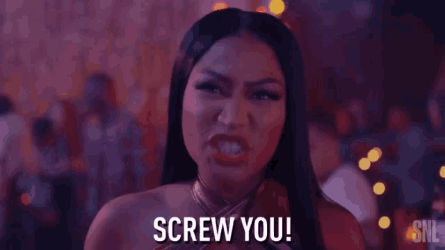 a woman is standing in front of a crowd and saying `` screw you ! ''