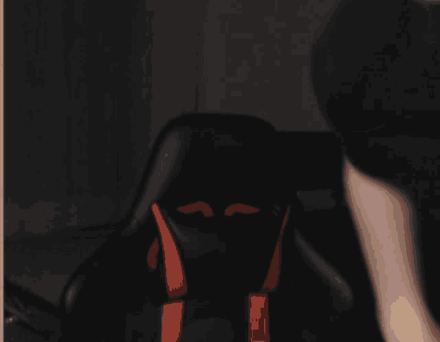 a blurry picture of a man 's face with an orange circle on his forehead