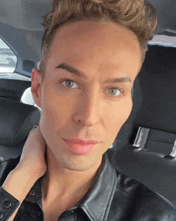a close up of a man 's face while sitting in a car