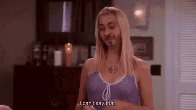 a woman with blonde hair and a beard is talking to a man with a beard .