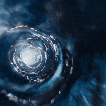 a close up of a water swirl with a light at the end of it .