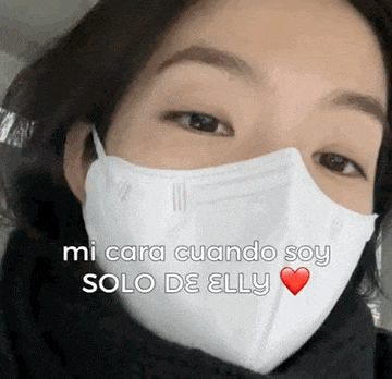 a woman wearing a white face mask with a heart on her face .