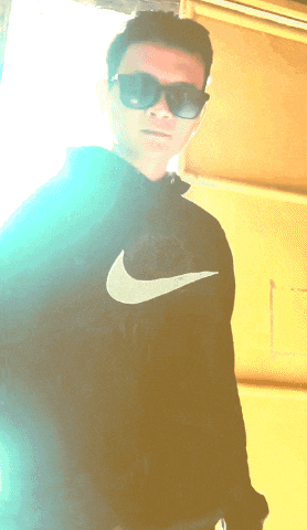a young man wearing sunglasses and a black nike sweatshirt