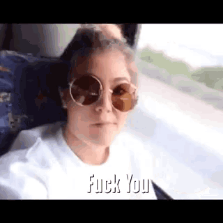 a woman wearing sunglasses says fuck you