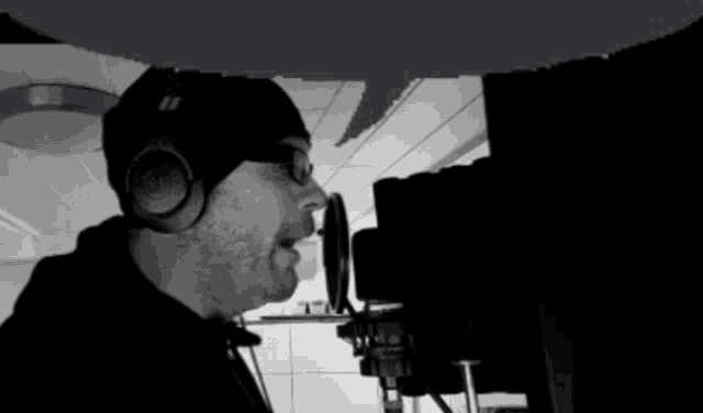 a man singing into a microphone with headphones on