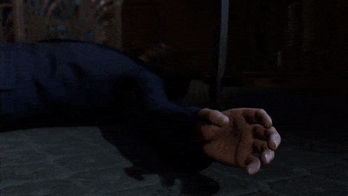 a man laying on the floor with a bandage on his face