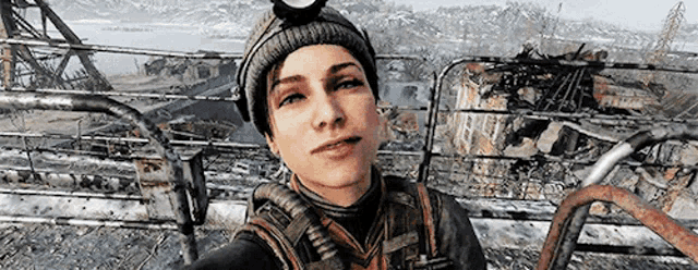a woman is taking a selfie in a video game while wearing a beanie and goggles .