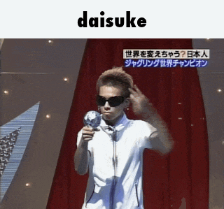 a man in sunglasses is holding a microphone in front of a red curtain under the word daisuke