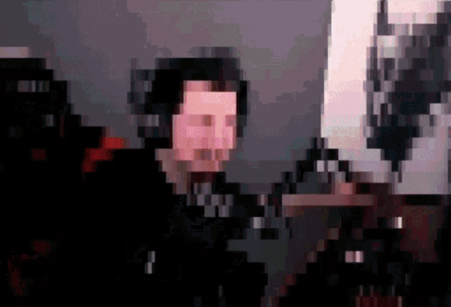 a pixelated image of a man 's face with a gray background