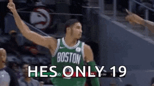 a basketball player in a green jersey is giving a thumbs up while standing on a court .