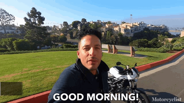 a man sitting next to a motorcycle says " good morning "