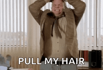 a man in a suit and tie is pulling his hair in a office .