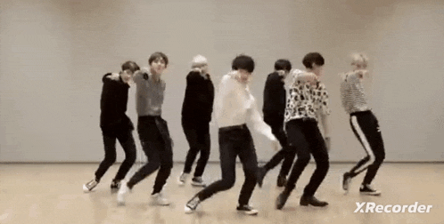a group of young men are dancing together in a studio .