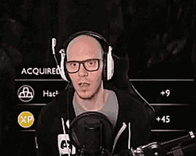 a man wearing headphones and glasses is talking into a microphone