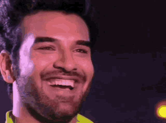 a close up of a man 's face with a smile on his face