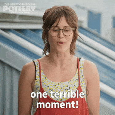 a woman wearing glasses and a red tank top says " one terrible moment "