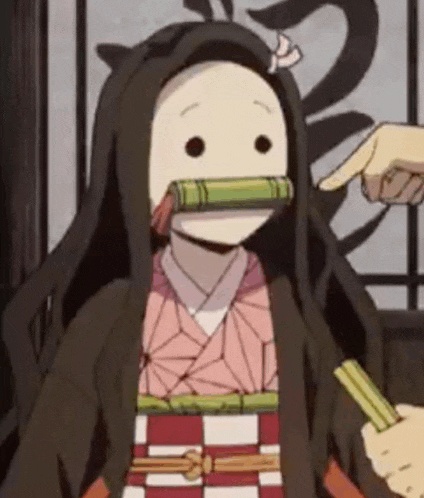 a close up of a person pointing at a cartoon character with chopsticks .