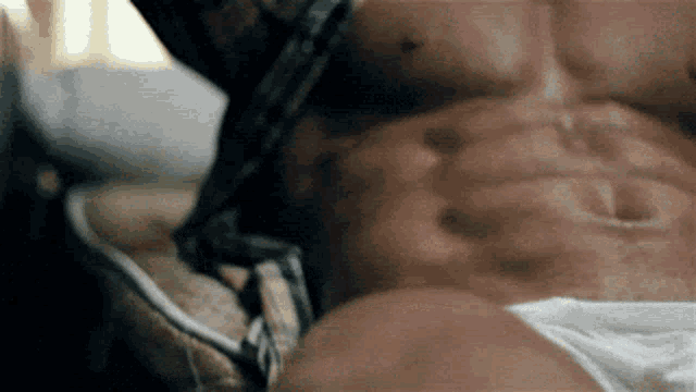 a close up of a man 's torso with his shirt off .