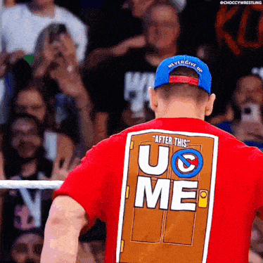 a man wearing a red shirt that says " after this u & me "