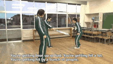 a group of people are standing in a classroom with the words you 're getting beat up so bad written below them
