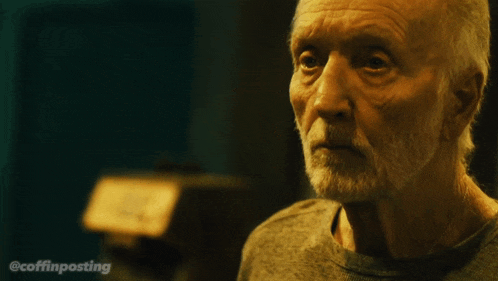 a close up of an older man with a beard and the words @coffinposting