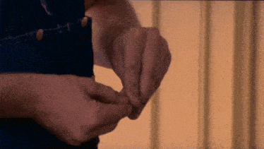a close up of a person 's hands on a denim shirt