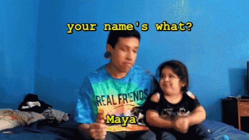 a man wearing a tie dye real friends shirt sits next to a little boy