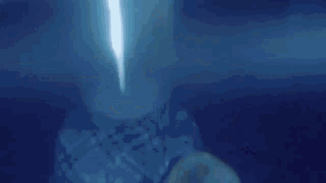 a woman is swimming in a pool at night and smiling at the camera .