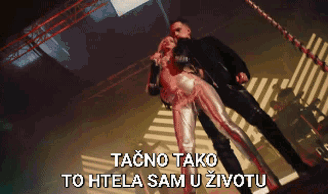 a pixelated image of a man and a woman with the words tacno tako to htela sam u životu