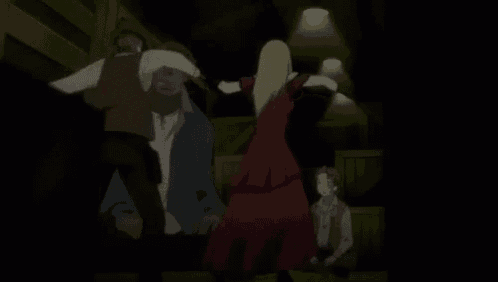 a group of people are standing around a woman in a red dress .