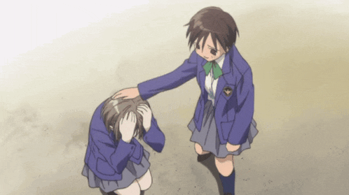 a girl in a blue jacket is putting her hand on another girl 's forehead