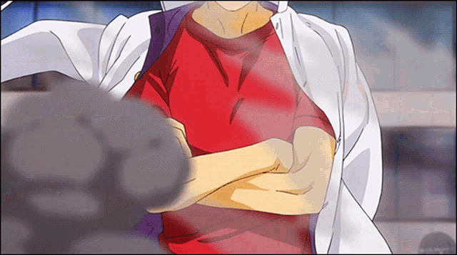 a person with their arms crossed and a red shirt