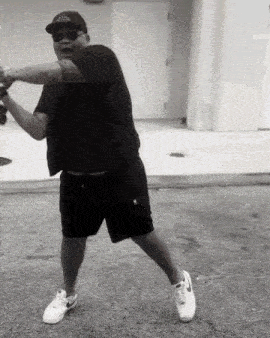 a black and white photo of a man wearing a hat that says adidas on it