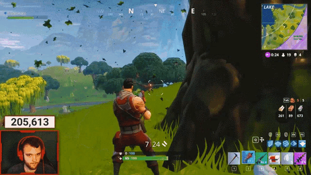 a man playing a video game with the number 205,613 on the bottom