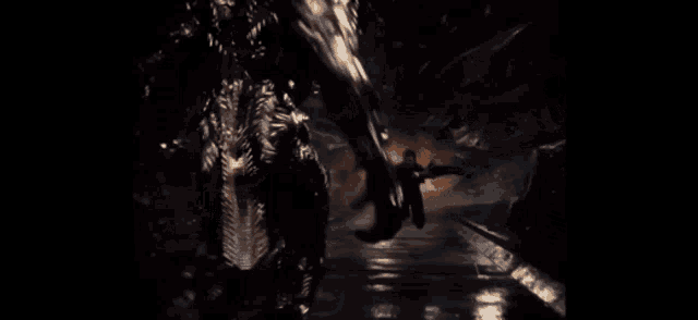 a person is flying through the air in a dark room with fire coming out of the ground .
