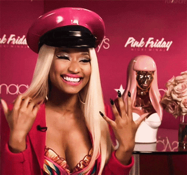 a woman wearing a pink hat is smiling in front of a pink background that says pink friday