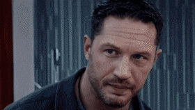 a close up of a man 's face with a beard and a black shirt .