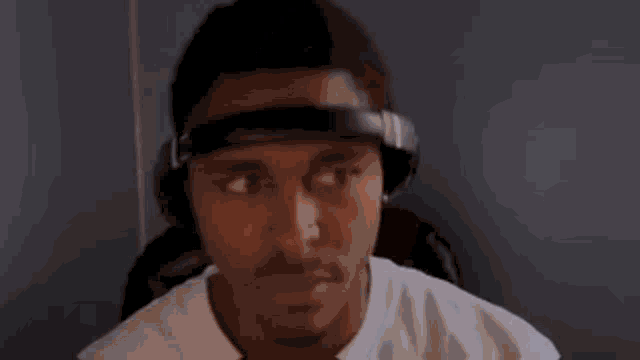a man wearing headphones is making a funny face .