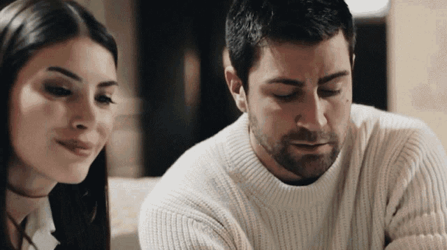 a man and a woman are looking at each other