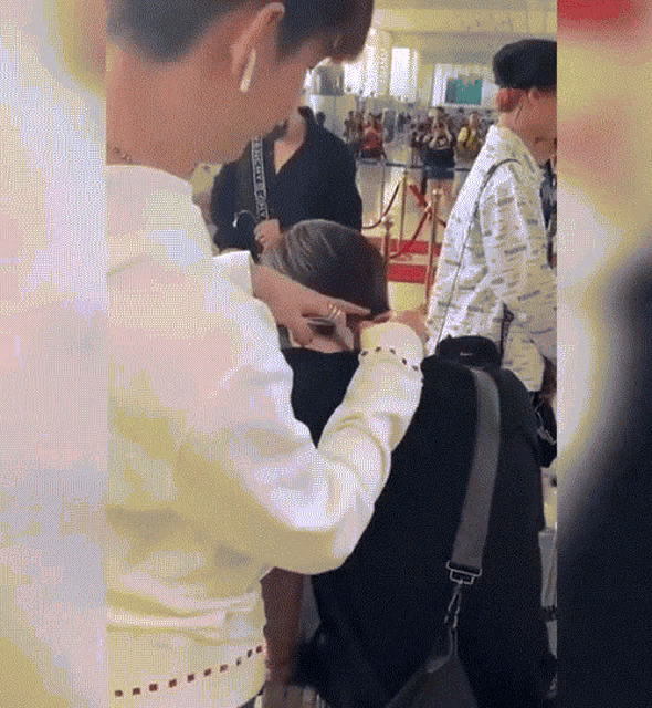 a woman in a white shirt has the word gucci on her shoulder