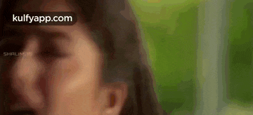 a close up of a woman 's face with her eyes closed