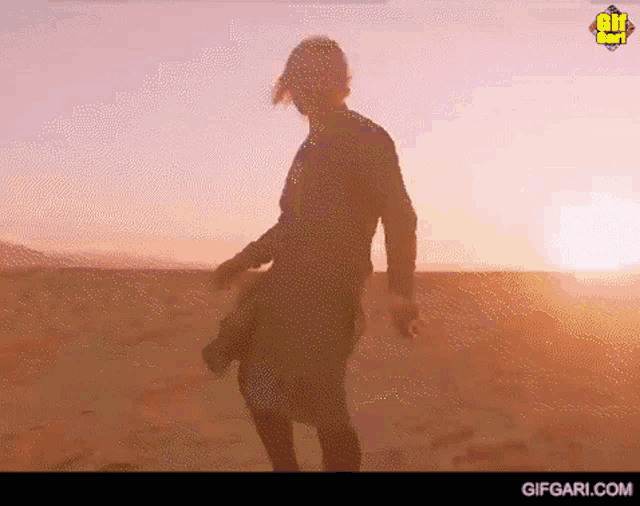 a gif of a person dancing in the desert with gifgari.com in the bottom right corner
