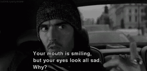 a man in a beanie is sitting in a car with a quote on his face .