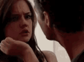 a man and a woman are looking at each other .