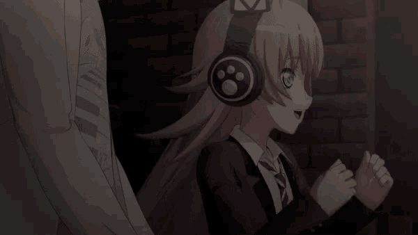 a girl wearing headphones giving a thumbs up sign