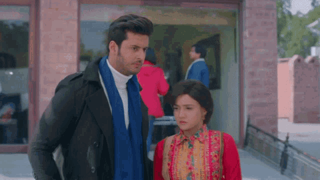 a man and a woman are standing next to each other