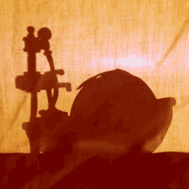 a shadow of a faucet and a bowl on a red cloth