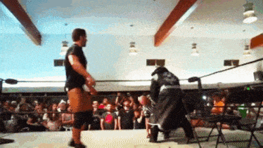a wrestler in a black jacket with the letter s on it
