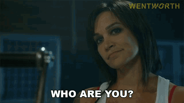 a woman says " who are you " in front of a sign that says " wentworth "